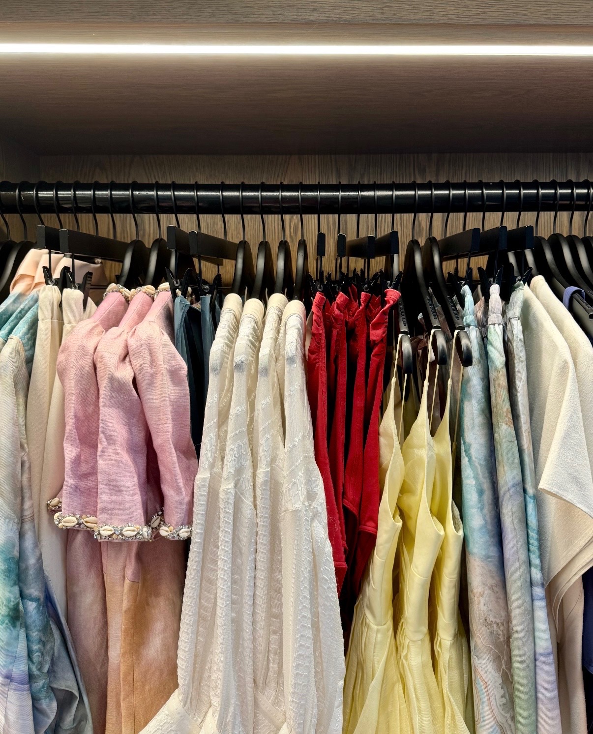 Pastel pink, white, red, yellow, and blue resort apparel arranged in Anguilla