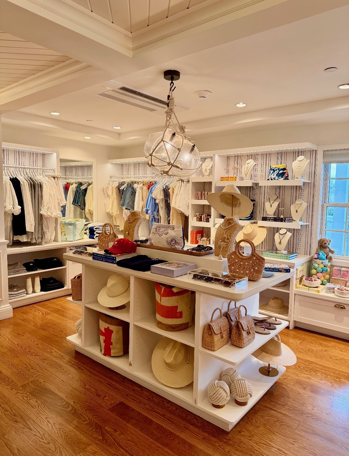 Completed Nantucket property with styled apparel, jewelry, accessories, books, and display tables