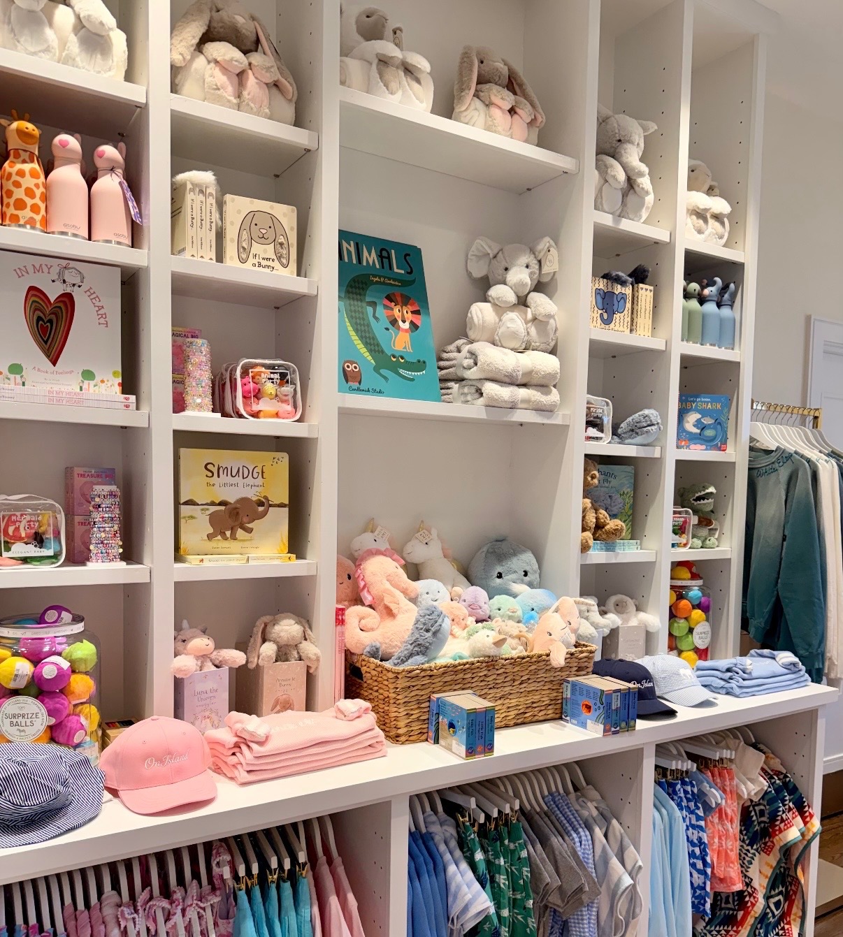 Completed Nantucket children’s display with books, plush toys, accessories, and apparel arranged on white shelving