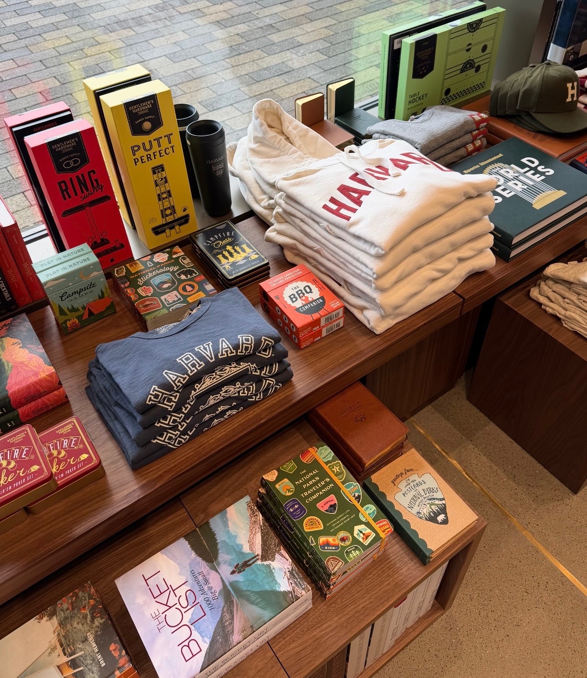 Completed Harvard display with collegiate apparel, games, books, and gifts arranged on wood fixtures