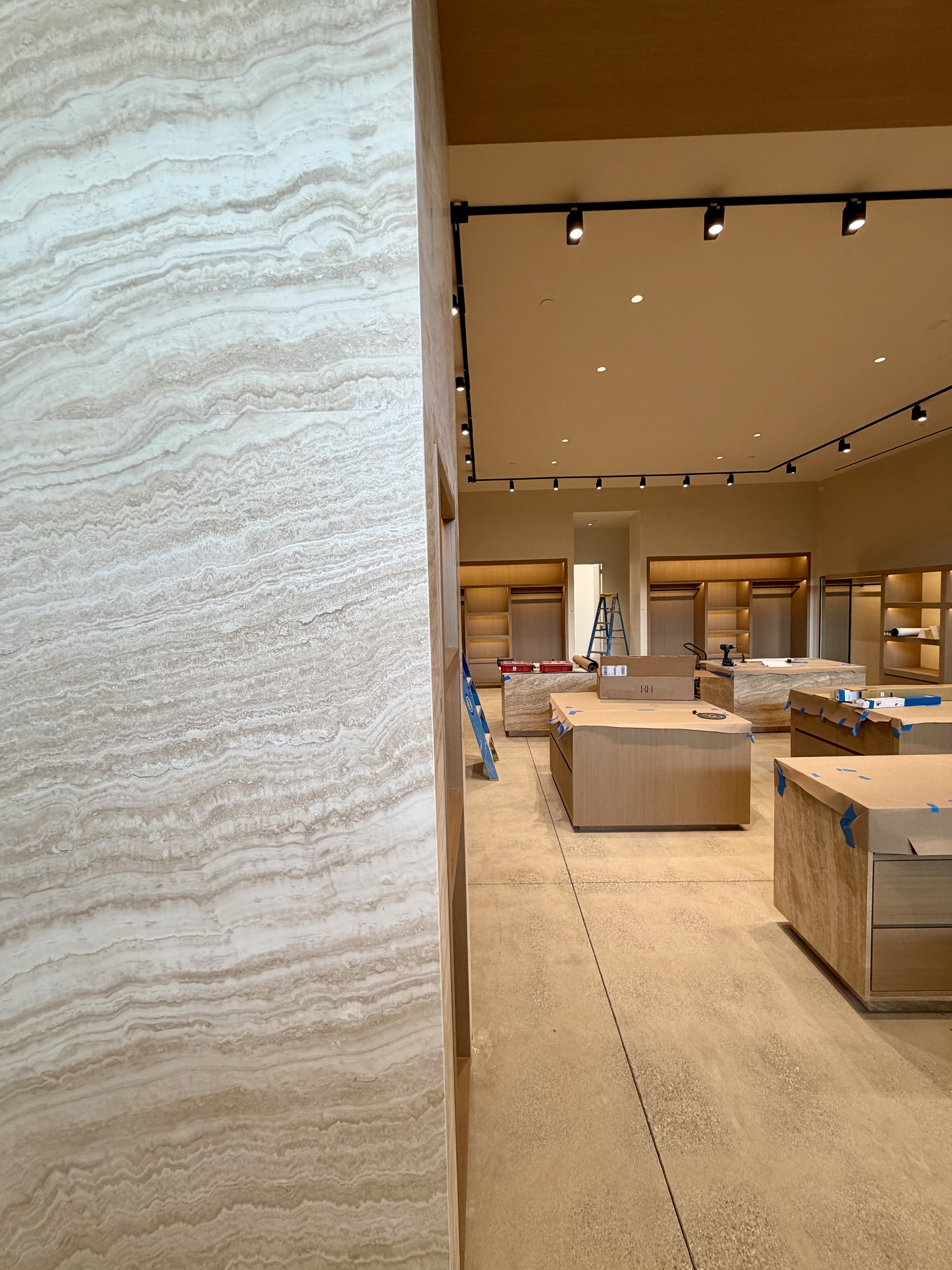 Malibu boutique before merchandising, with new fixtures and display tables under installation