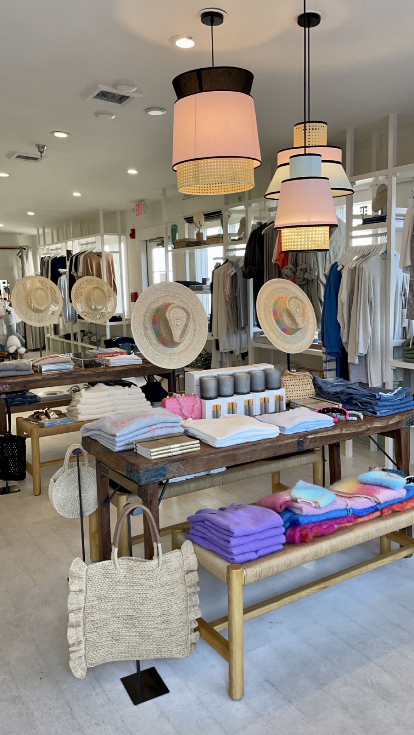 Martha’s Vineyard boutique with colorful pendant lights, layered display tables, hats, apparel, and accessories