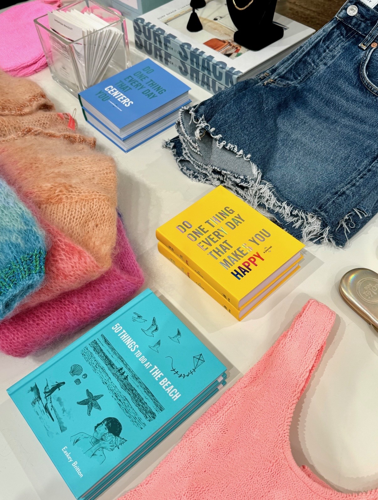 Colorful books, knitwear, denim, jewelry, and resort accessories styled at The Ritz-Carlton Kapalua retail shop
